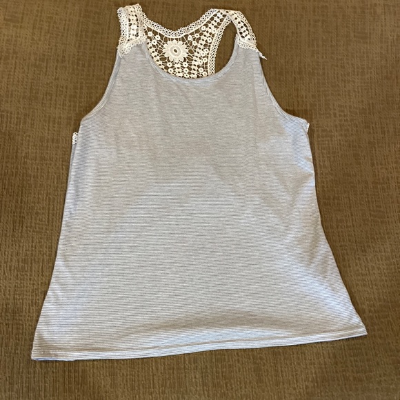 I am selling this cute tank top, it says large but it fits me well I’m a small - Picture 1 of 4